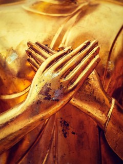 Vintage retro effect filtered hipster style image of gold Buddha statue hands close up in Wat Phra That Doi Suthep