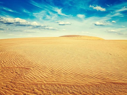 Vintage retro effect filtered hipster style image of white sand dunes on sunrise