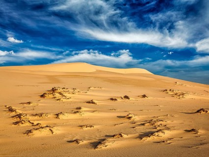 White sand dunes in desert on sunrise