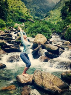Vintage retro effect hipster style image of sporty fit woman doing yoga asana Utkatasana