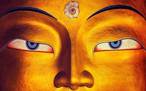 Vintage retro effect filtered hipster style image of eyes of Maitreya Buddha face close up. Thiksey Gompa. Ladakh