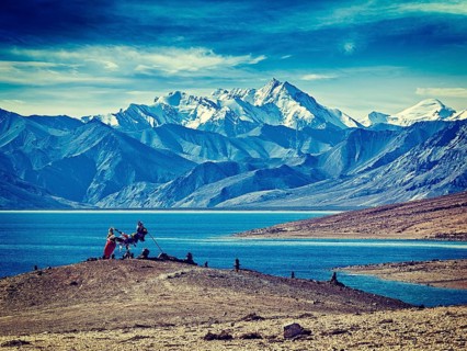 Vintage retro effect filtered hipster style image of Buddhist prayer flags lungta at Himalayan lake Tso Moriri in the morning. Korzok