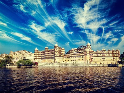 Vintage retro effect filtered hipster style image of City Palace view from the lake. Udaipur