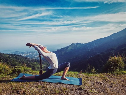 Vintage retro effect hipster style image of sporty fit woman practices yoga Anjaneyasana