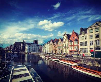 Vintage retro hipster style travel image of travel Belgium medieval european city town background with canal. Koperlei street