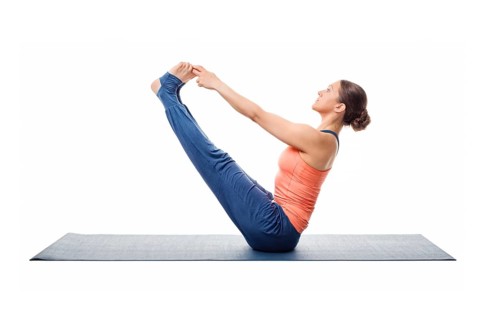 Beautiful sporty fit woman practices yoga asana Ubhaya padangusthasana