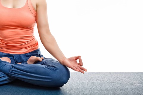 Close up of woman doing yoga asana Padmasana