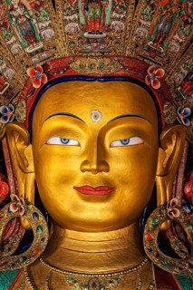 Maitreya Buddha statue face close up in Thiksey Gompa. Ladakh