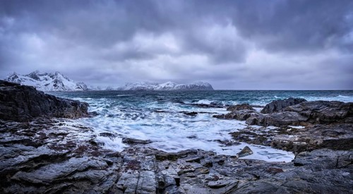 Panorama of waves of Norwegian sea crushing at rocky coast in fjord. Vikten