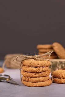 Stack of healthy homemade oat cookies in front of gray background