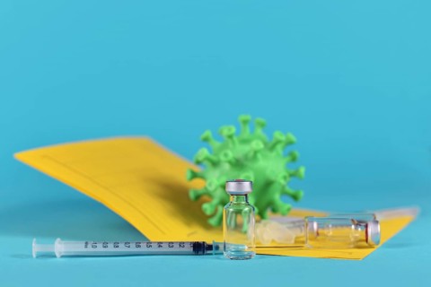 Booster vaccination against Corona concept with vials and syringes