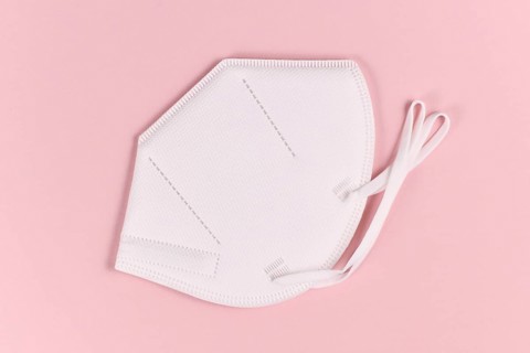 Medical FFP2 respirator mask on pink background
