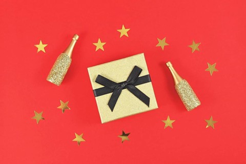 Golden gift box with black bow