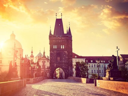Vintage retro hipster style travel image of Charles bridge old town tower in Prague on sunrise