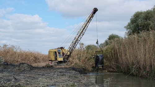 Excavator deepens and widens the canal between the Danube River and the lakes