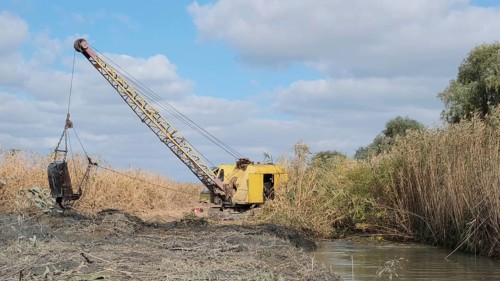 Excavator deepens and widens the canal between the Danube River and the lakes