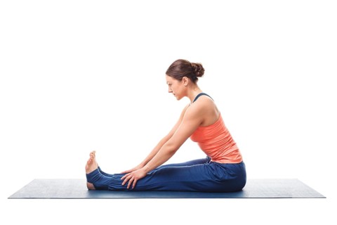 Sporty fit woman doing Ashtanga Vinyasa yoga back bending asana Paschimottanasana