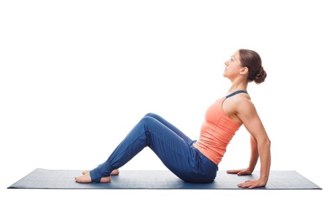 Woman preparing for yoga asana Upward Plank Pose