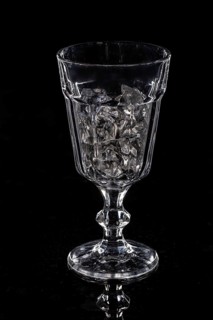 Glass with crystals of ice on a glass background
