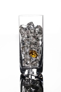Crystals of ice in a glass with water on a glass background