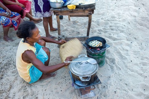 Malagasy woman cooking outdoors