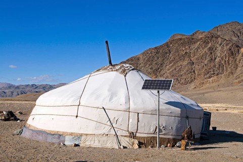 Kazakh nomad ger tent with solar panel and hooded Golden Eagle