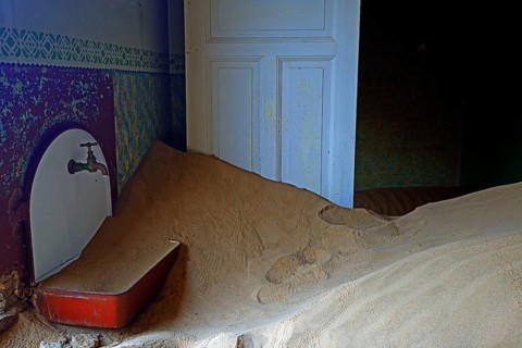Residential buildings taken over by desert sand