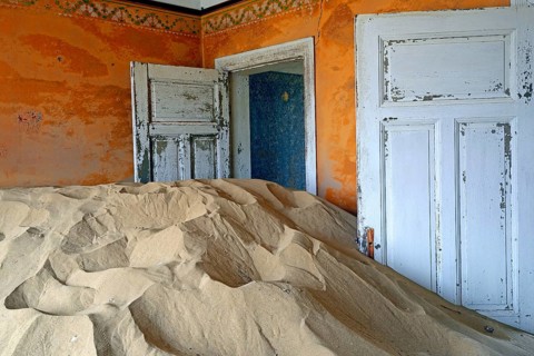 Residential buildings taken over by desert sand