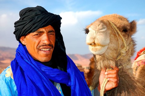 Man with dromedary camel