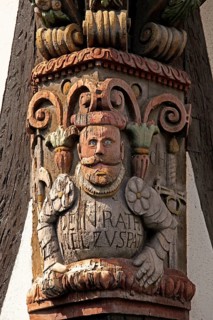 Artful carvings on corner beams of half-timbered house