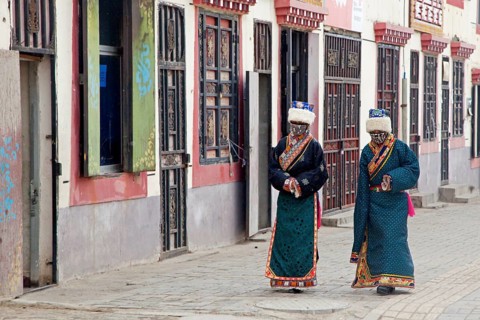 Two Tibetan woman in traditional dress in Maduo. Madoi County in the southeast-central province of Qinghai