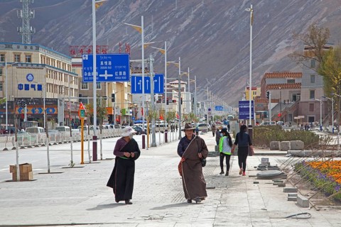 Tibetan woman in traditional dress wear masks to protect themselves from pollution in Yushu city