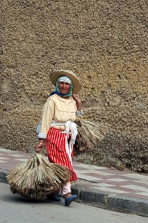 Old Berber woman carrying goods to market in Tetouan