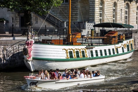 Tourists in a boat on the river Leie
