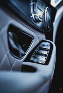 Detail of a vehicle door covered with white leather of a Mercedes AMG