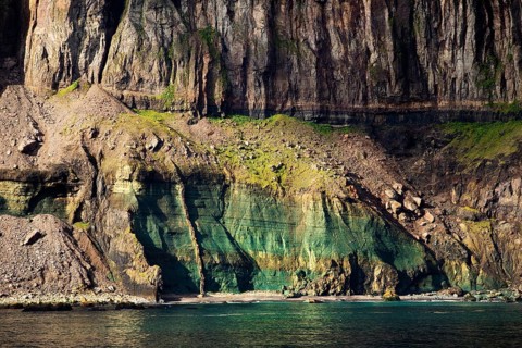 Steep coast with colourful bay at the fjord Seydisfjoerdur