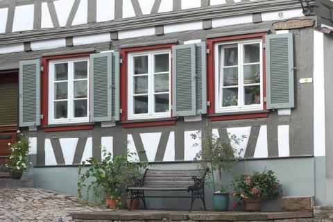 Half-timbered house with three shutters and bench in Schlossbergstrasse