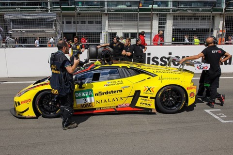 Lamborghini Huracan GT3 with racing team in front of start of car race
