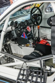 View inside cockpit of racing car Porsche Cayman R in grid lane in front of start of car race