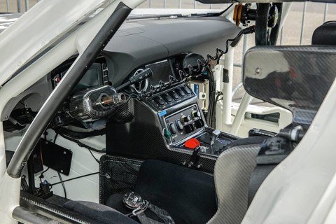 View inside cockpit of racing car Mercedes-AMG GT3 with bucket seat centre console electronic controls