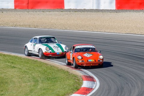 Two historic racing cars Porsche 911 close together in curve at car race for classic cars Youngtimer Classic Cars 24-hour race 24h race