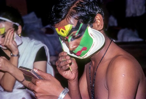 A Katakali artist applying makeup