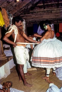 Kathakali actor being fitted with his costume