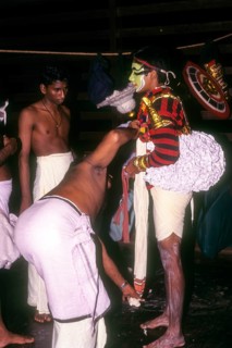 Koodiyattam Kodiyattom actor being fitted with his costume