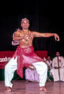 Kalamandalam Gopi demonstrating kathakali exercise in Kerala Kalamandalam