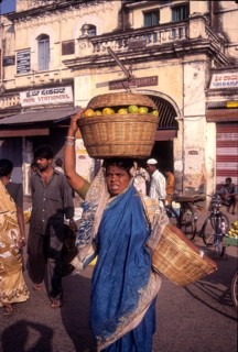 Lady struggling with heavy luggage