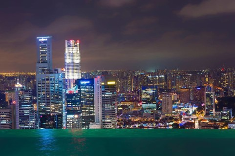 The city's central financial district at night as seen from the infinity pool of the Marina Bay Sands Hotel