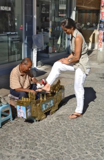 Shoeshine boy with customers