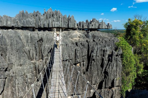 Climber crossing a suspension bridge