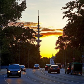 Cars on the Kennedy Bridge in front of the Heinrich Hertz Tower at sunset